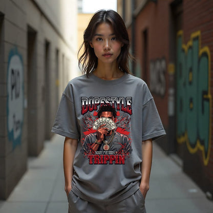 Person wearing a gray t-shirt with a graphic design and text in an urban setting