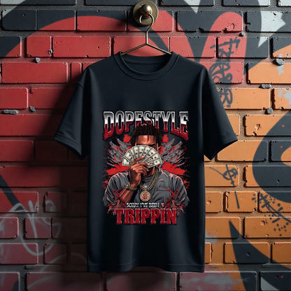 Black t-shirt with graphic design and text hanging on a brick wall.