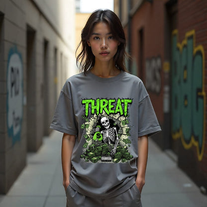 Person wearing a gray t-shirt with a graphic design in an urban setting