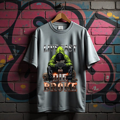 Gray t-shirt with graphic design and text 'Live Fast or Die Broke' on a graffiti-covered wall.