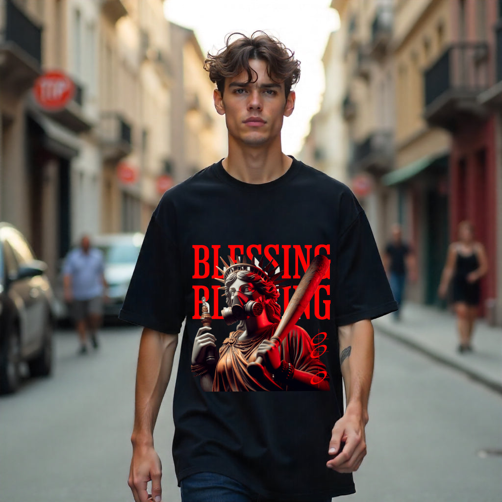 Person wearing a black t-shirt with a graphic design on a city street