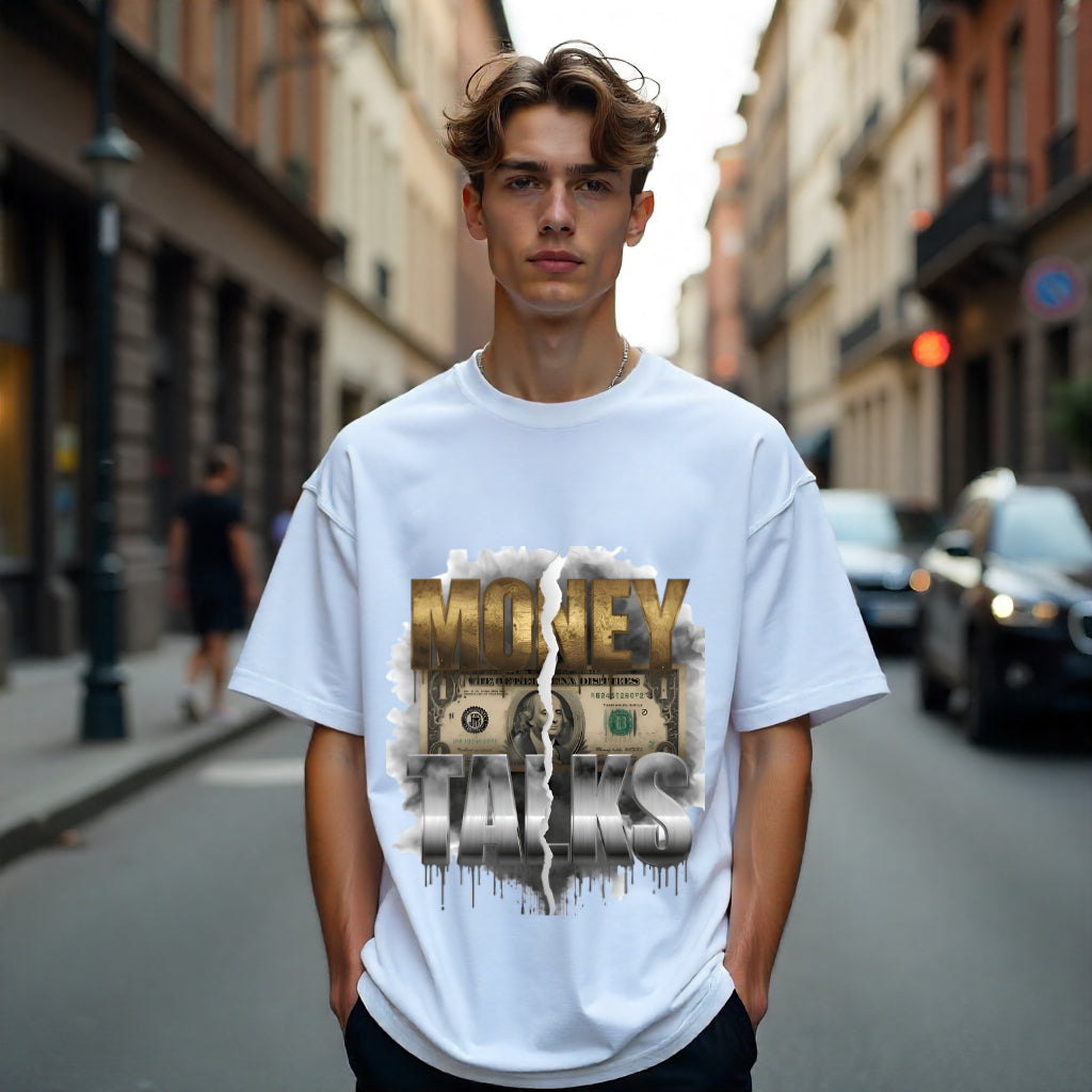 Person wearing a white t-shirt with 'Money Talks' graphic on a city street.