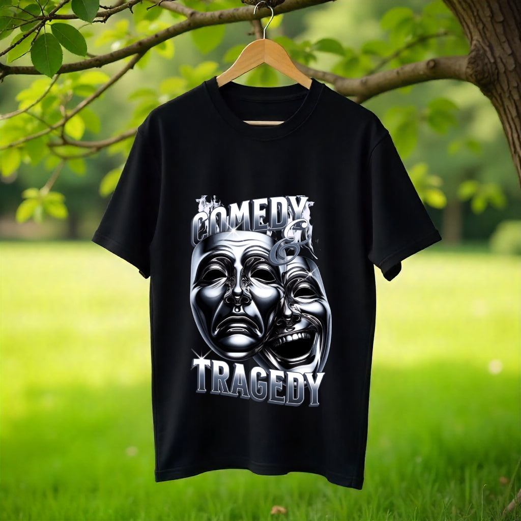 Black t-shirt with 'Comedy Tragedy' design on a hanger against a natural background