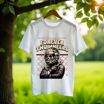 White t-shirt with 'Forever Two Wheels' graphic design hanging on a tree branch with a natural background.