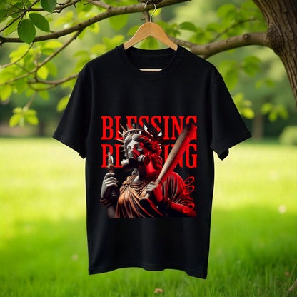 Black t-shirt with graphic design and text hanging on a hanger against a natural background